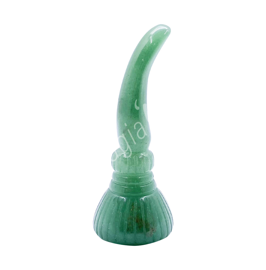 A carving of a witch's broom, made of green aventurine.