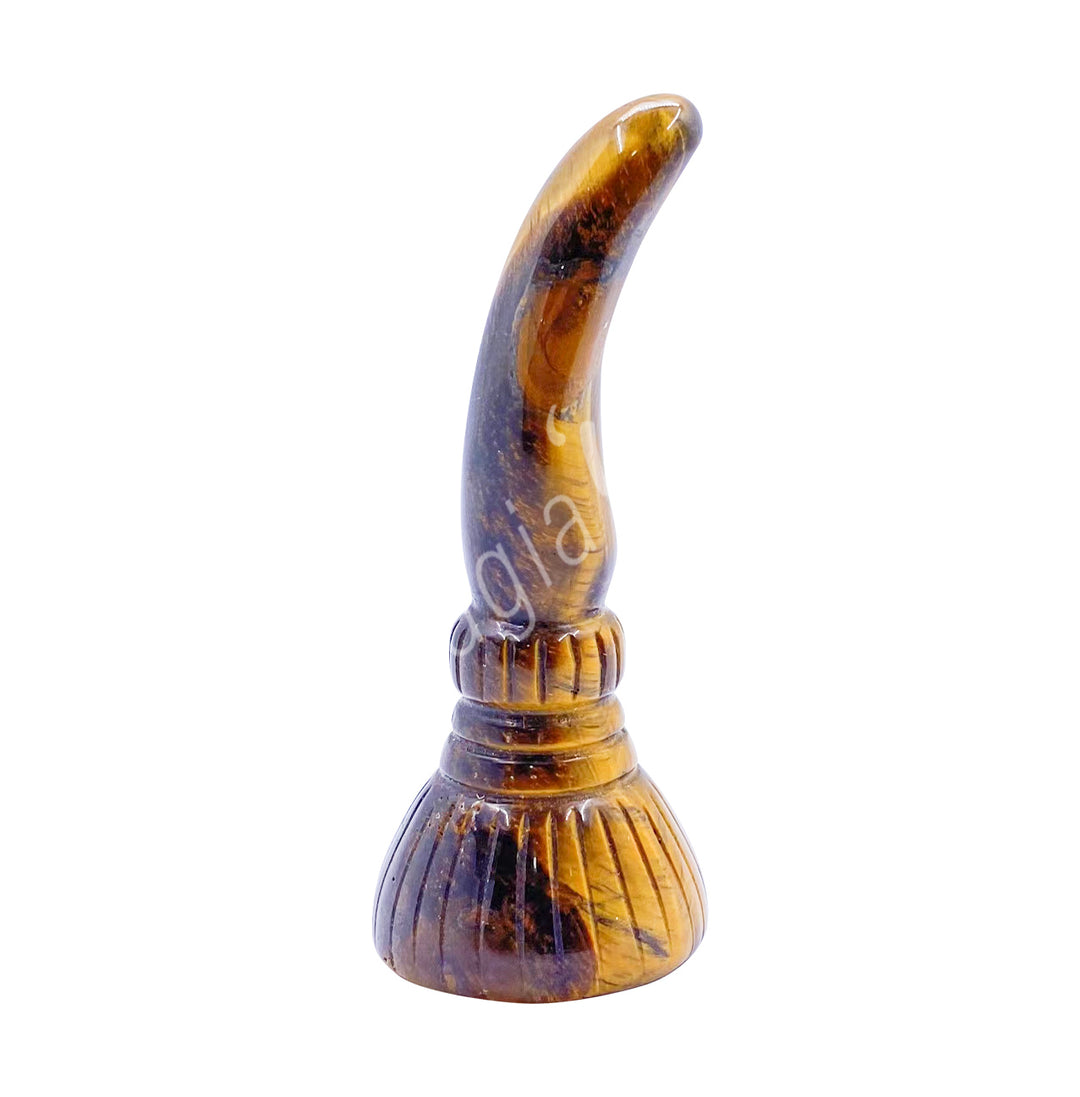 A carving of a witch's broom, made of tiger eye.