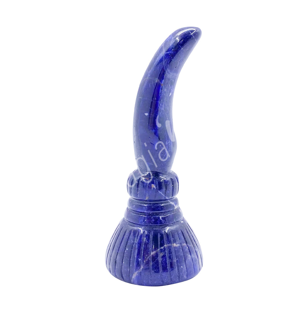 A carving of a witch's broom, made of sodalite.