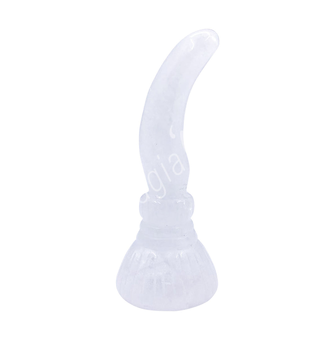 A carving of a witch's broom, made of crystal quartz.