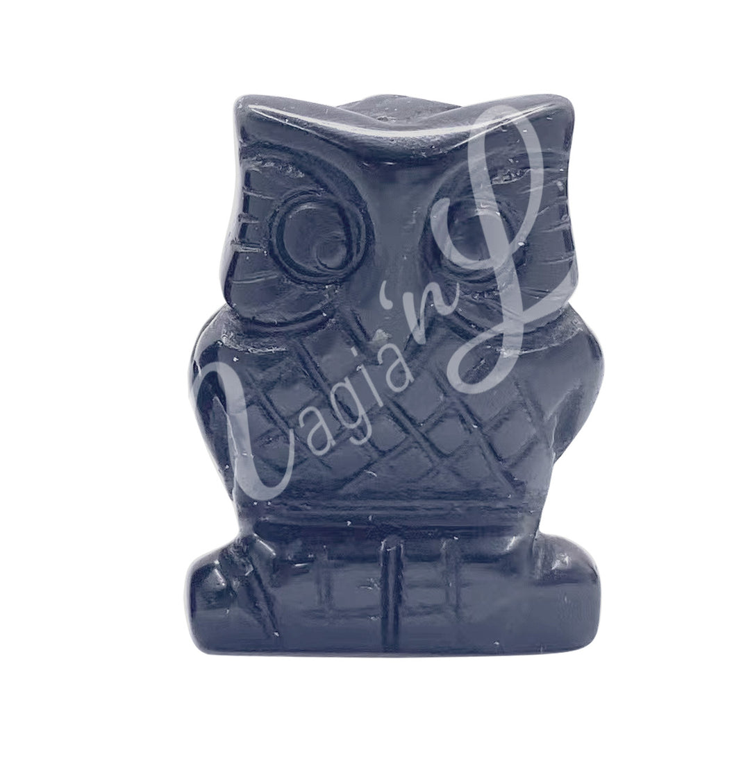 A carving of an owl made of black obsidian.