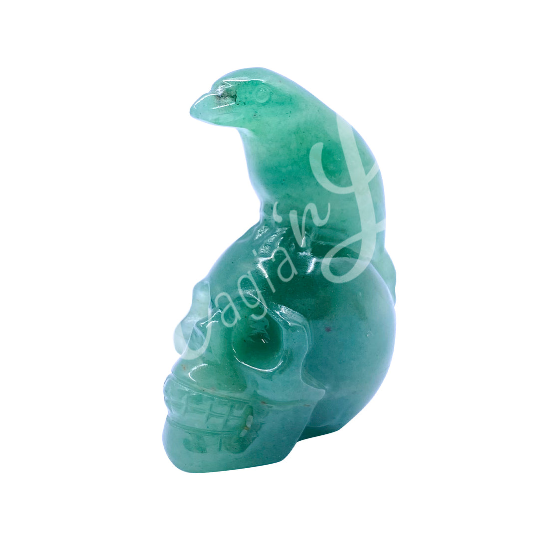 A polished raven on a skull carving made of green aventurine.