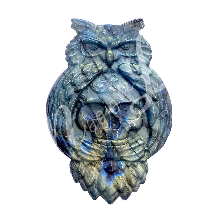 A carving of an owl with a skull to replace the belly, made of labradorite.
