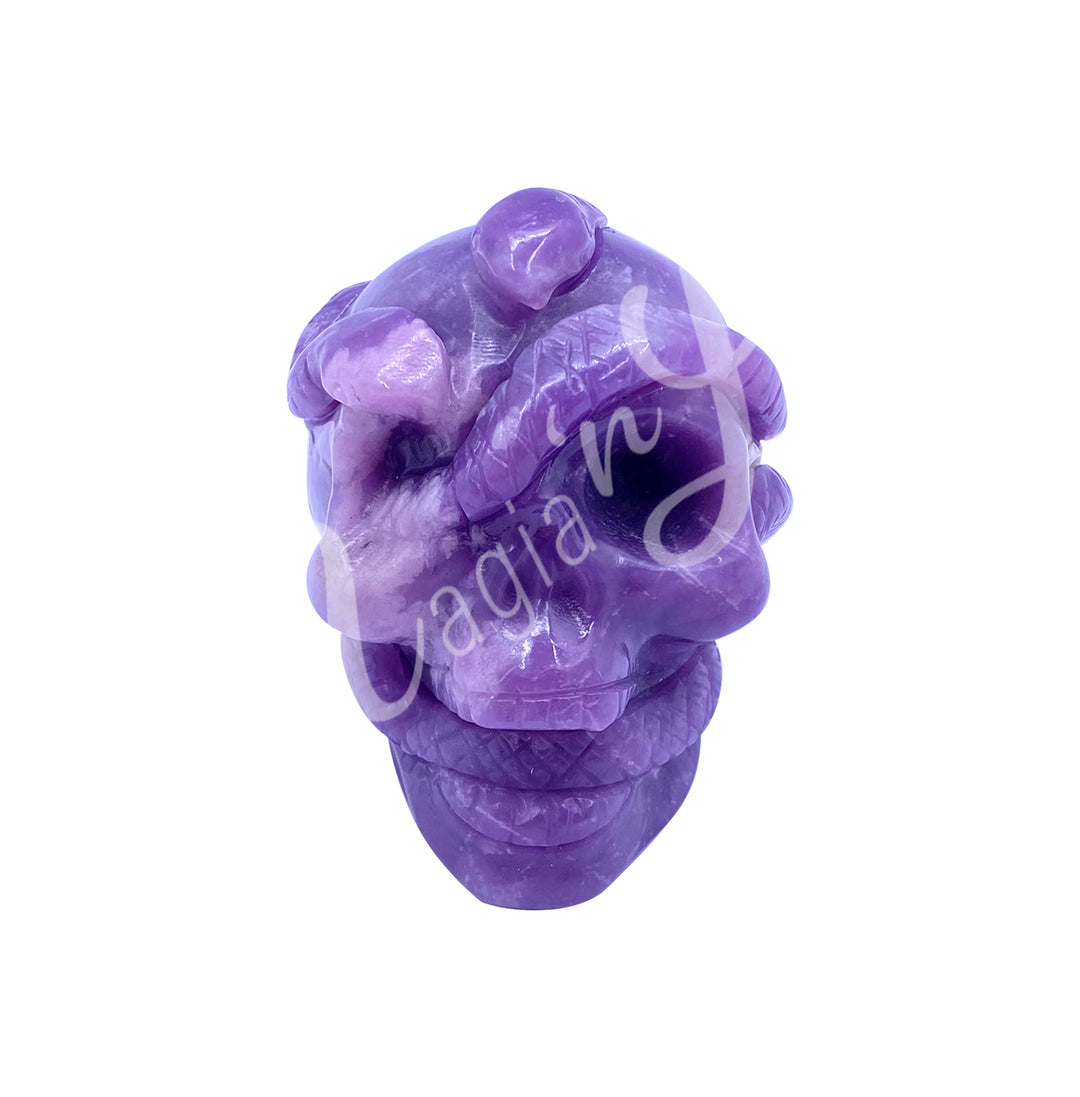 Polished gemstone skull with a snake carving made of lepidolite.