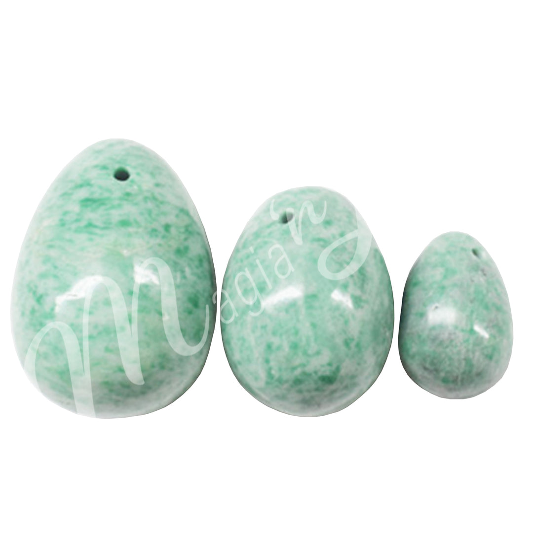 Three Jade eggs line from larger on the left to smallest on the right. A hole is visible near the top end of the eggs.