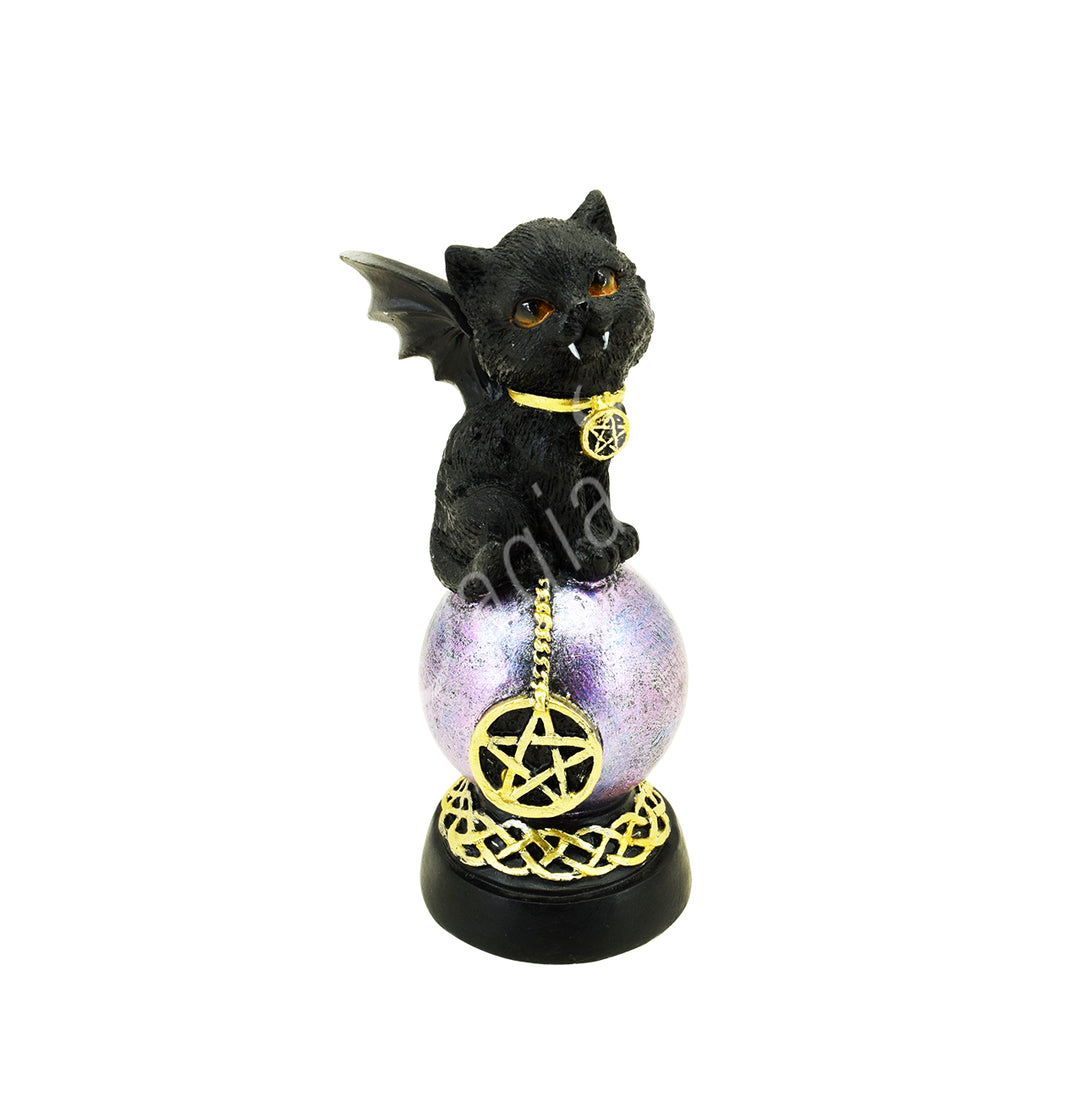 A statue of a vampire black cat wearing a collar with a pentacle charm, sitting on a chain with a pentacle charm, and perched on a sphere. The sphere rests on a black stand decorated with a Celtic knot design