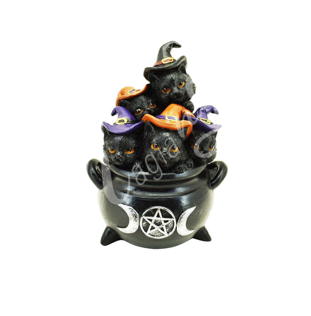 A statue of 5 kittens wearing witch hats, sitting in a cauldron. On the cauldron features a triple moon with a pentacle at its center.