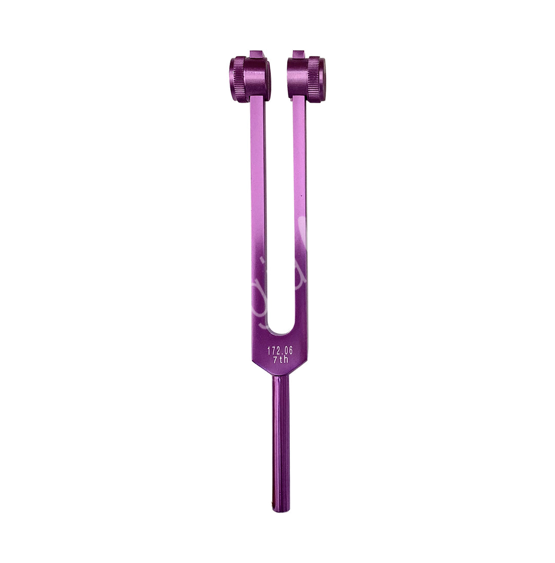 A purple tuning fork with the words "CROWN" engraved on it. It has two prongs with adjustable weights at the top, which are used to modify the vibration frequency.
