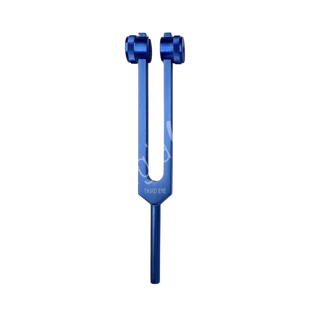 A blue tuning fork with the words "THIRD EYE" engraved on it. It has two prongs with adjustable weights at the top, which are used to modify the vibration frequency.