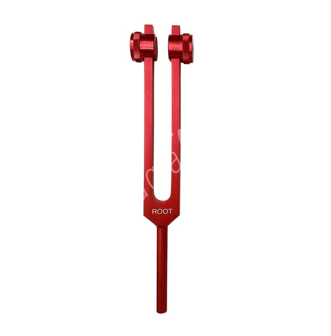 A red tuning fork with the words "ROOT" engraved on it. It has two prongs with adjustable weights at the top, which are used to modify the vibration frequency.