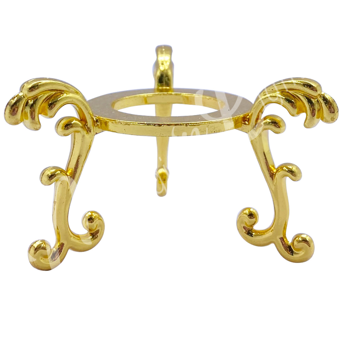 A gold-colored stand for spheres made of metal.