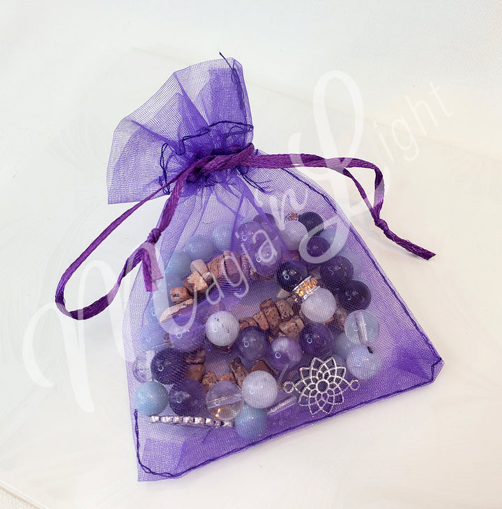 A close purple organza bag with bracelets inside.