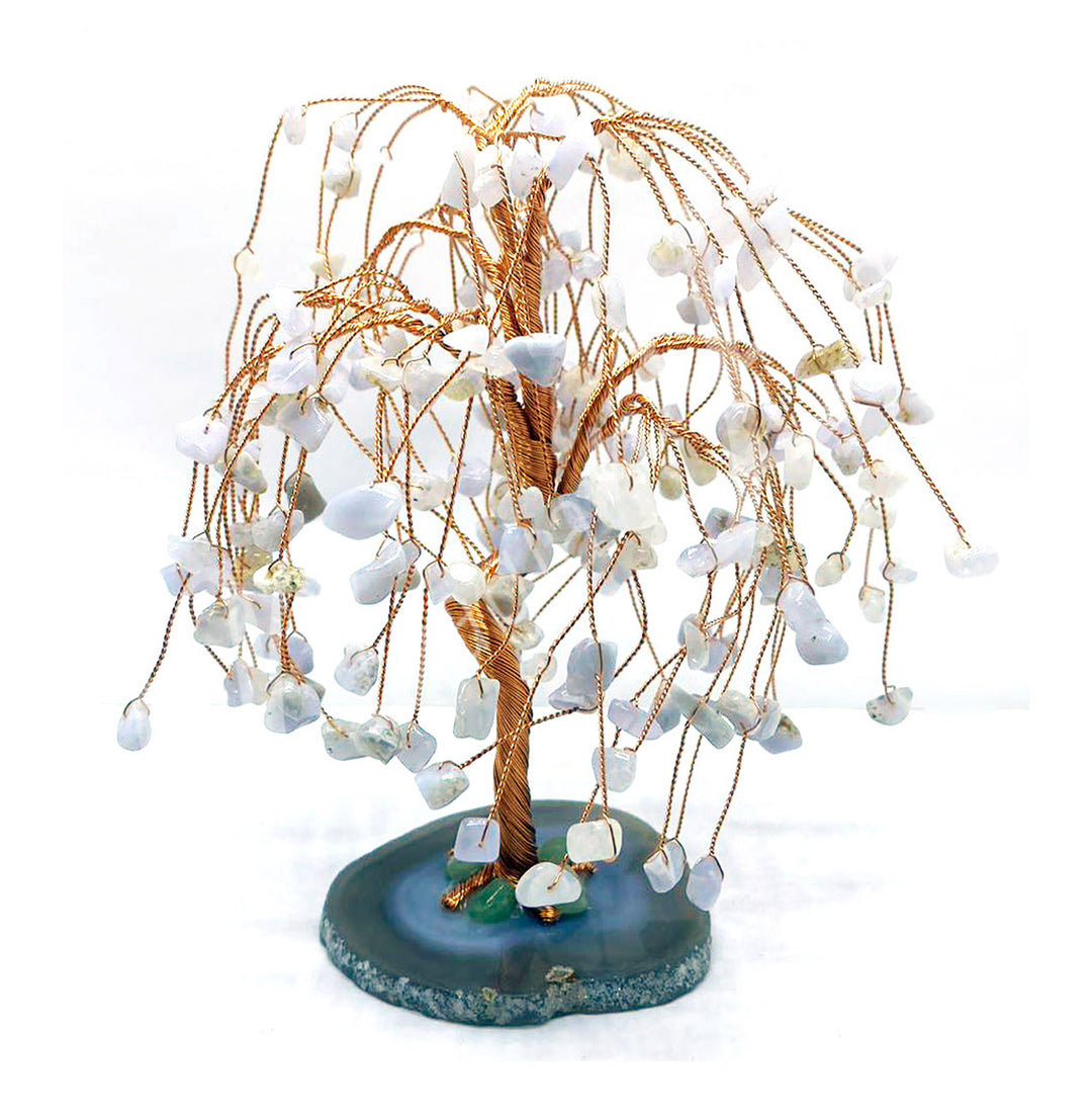 A wire gemstone bonsai tree with blue lace agate chips, mounted on a natural base.