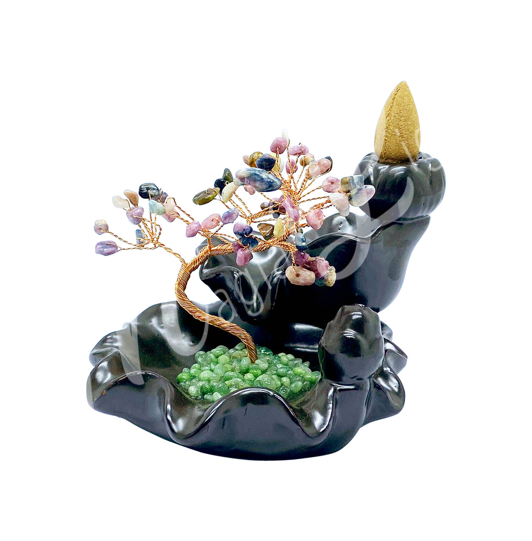 A gemstone bonsai tree with mixed tourmaline crystal chips, mounted on an ornate black dish that also functions as a backflow cone burner.