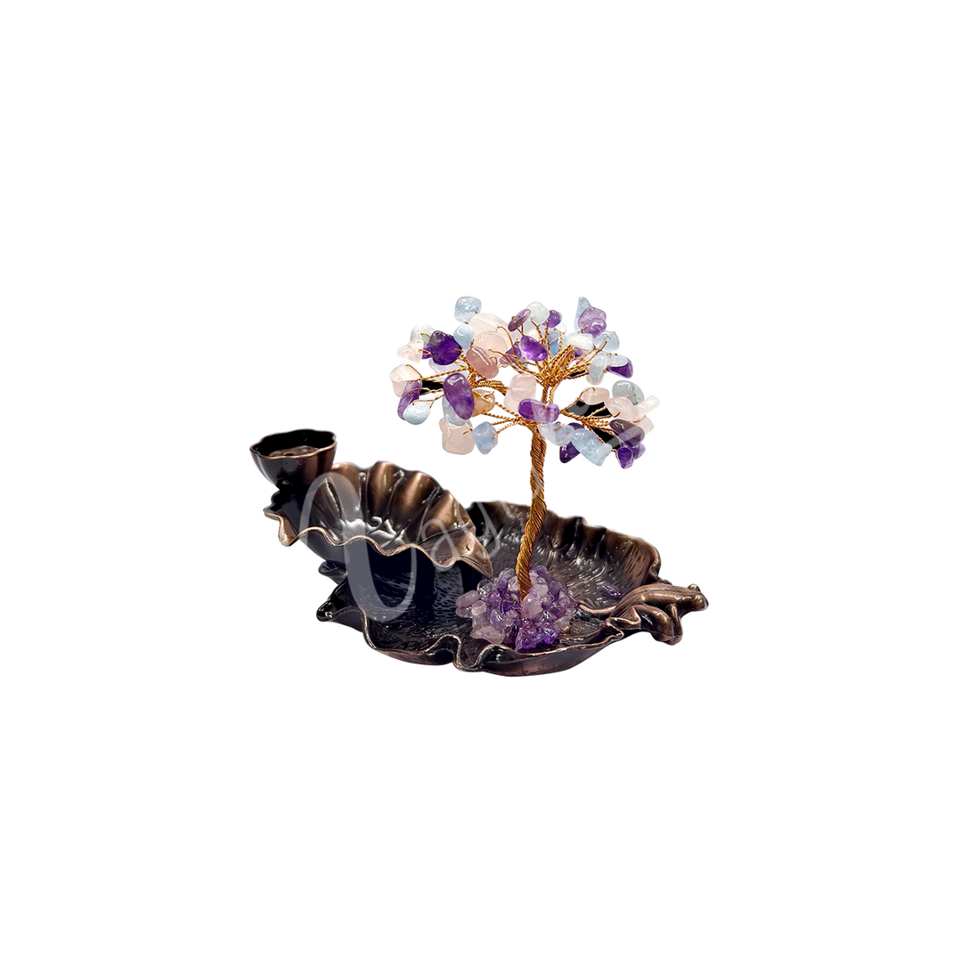 A gemstone bonsai tree with purple and clear crystal chips, mounted on an ornate black dish that also functions as a backflow cone burner.