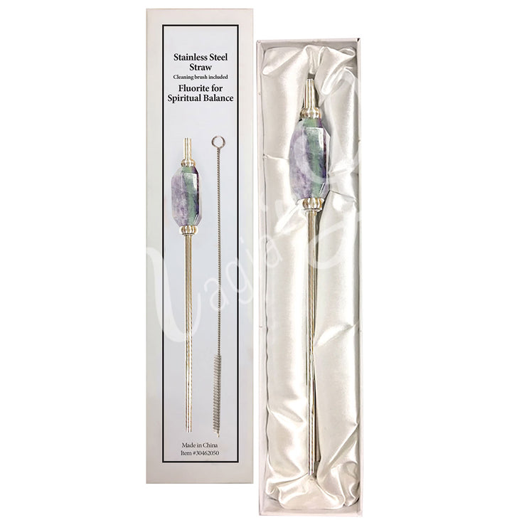 Stainless steel straw with a faceted fluorite stone accent, presented in a white satin-lined gift box. The packaging reads “Stainless Steel Straw, Cleaning brush included, Fluorite for Spiritual Balance”.