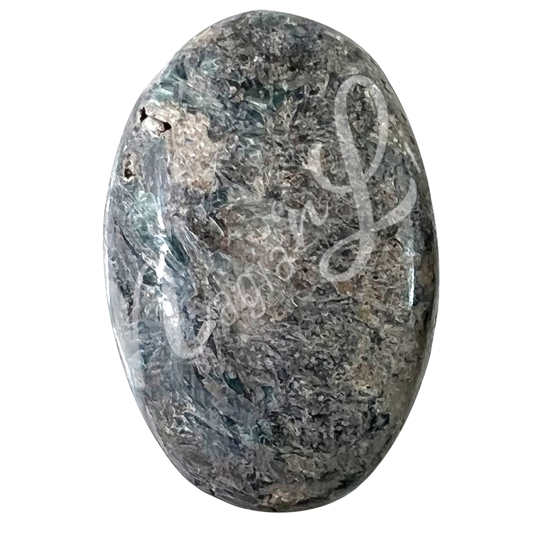 Close-up of a polished oval palm stone made of Kyanite.
