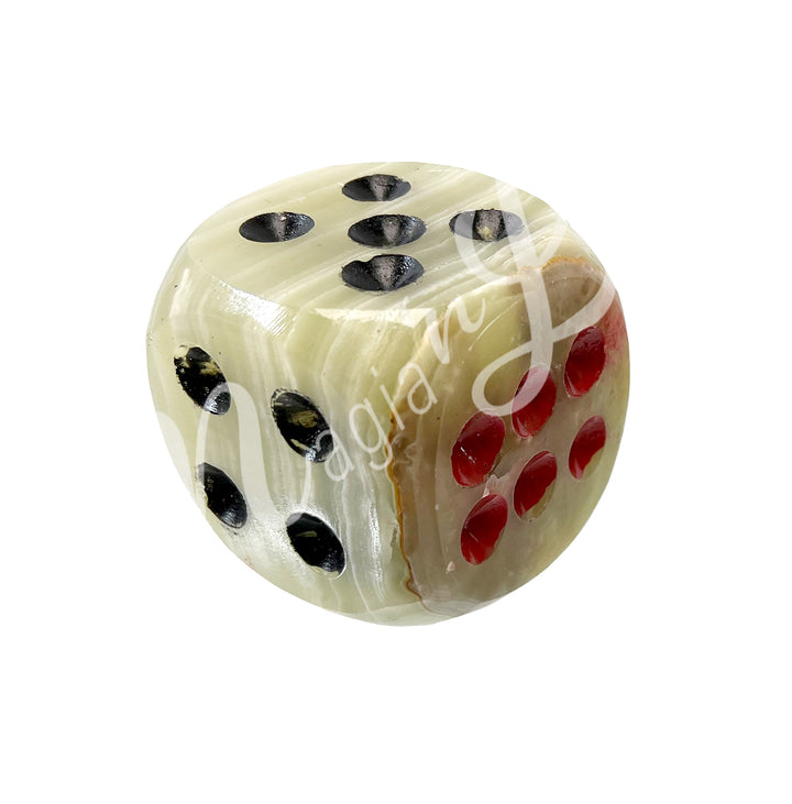 A polished green onyx gemstone dice with white engraved dots.