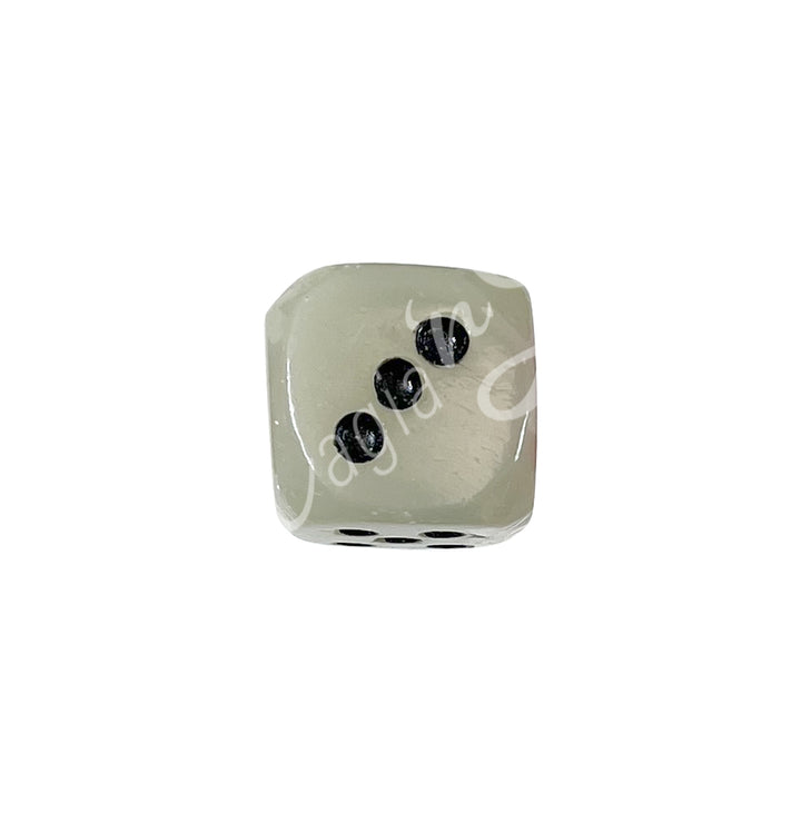 A polished green onyx gemstone dice with white engraved dots.