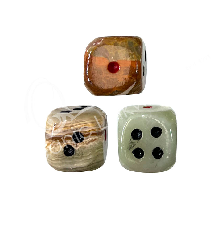 Set of three polished green onyx gemstone dice with white engraved dots.