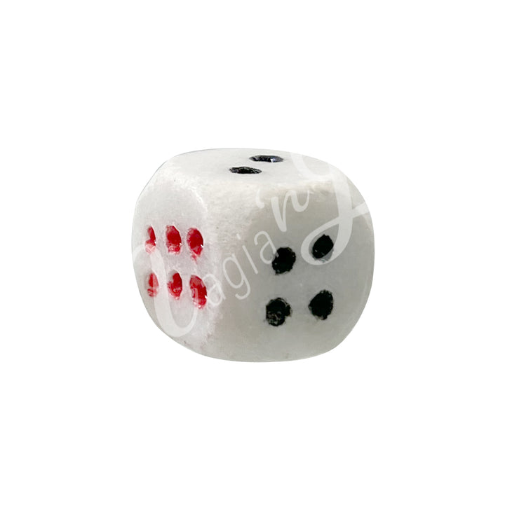 A polished white marble gemstone dice with white engraved dots.
