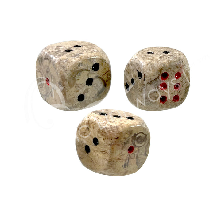 Set of three polished fossil coral gemstone dice with white engraved dots.