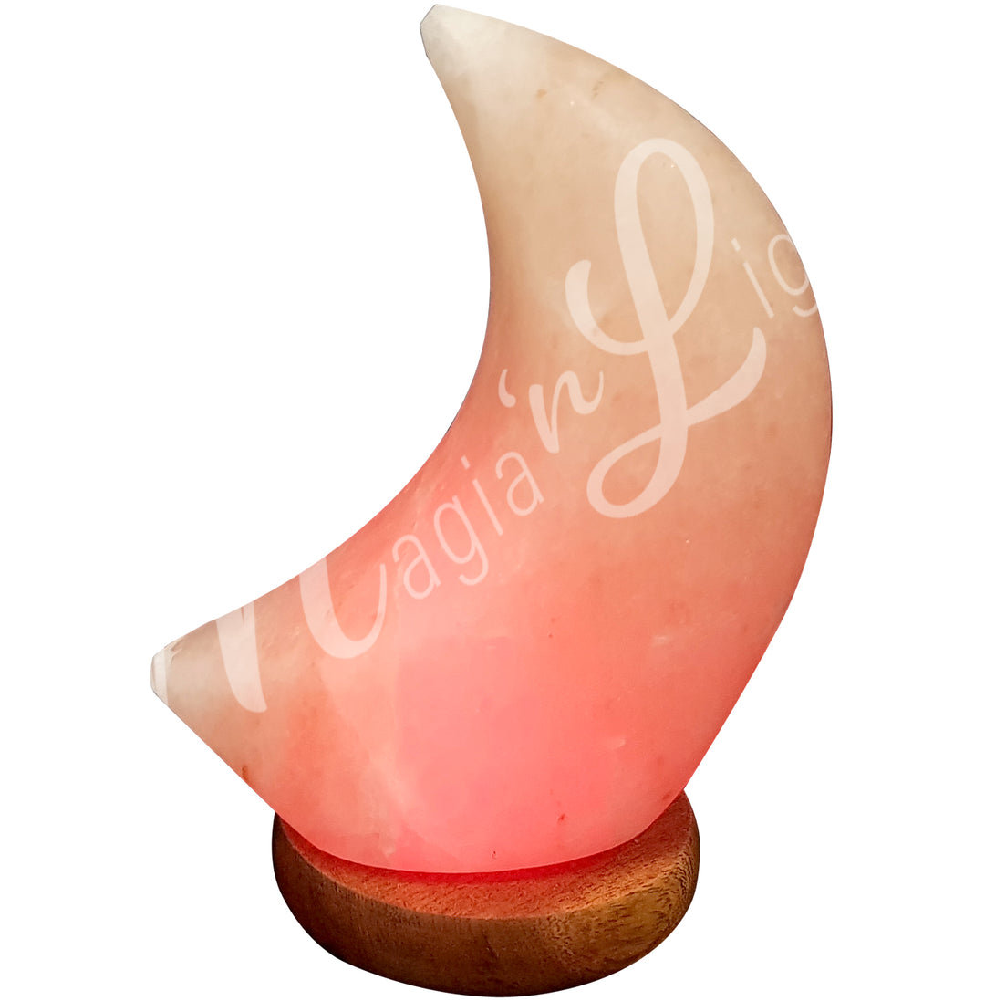 Moon-shaped salt lamp on wooden base.