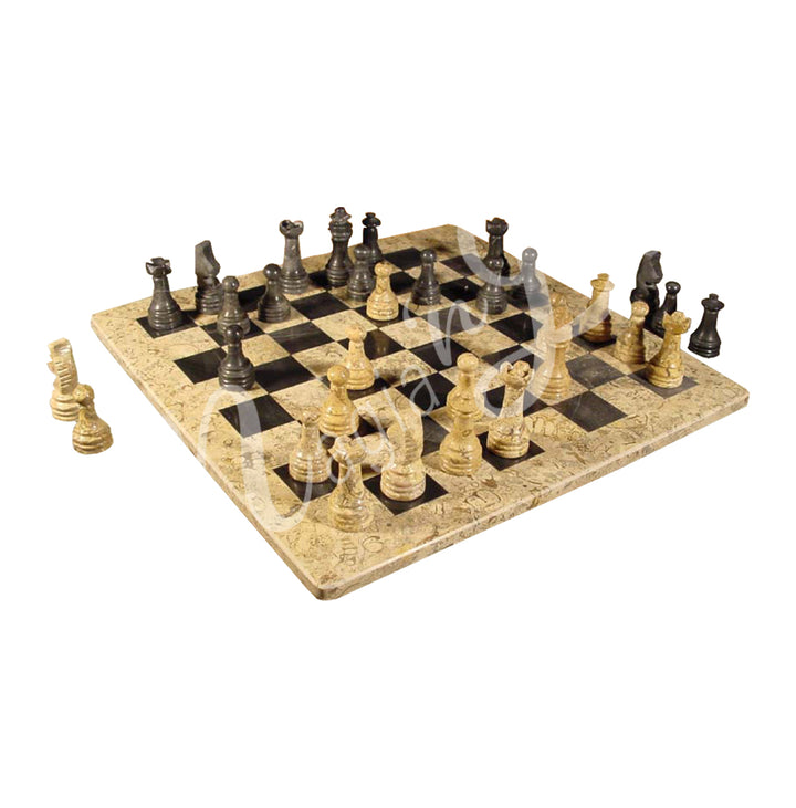 Coral chessboard with black marble and  coral chess pieces arranged for a game.