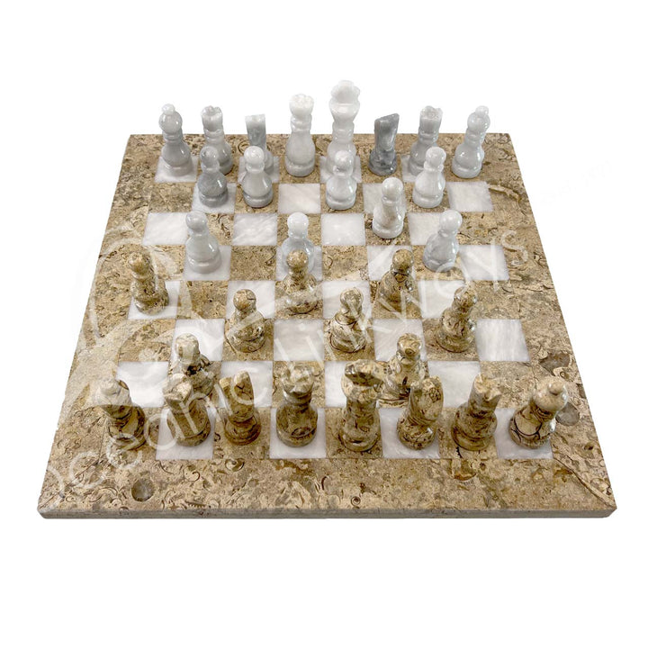 Coral chessboard with white marble and brown coral chess pieces arranged for a game.