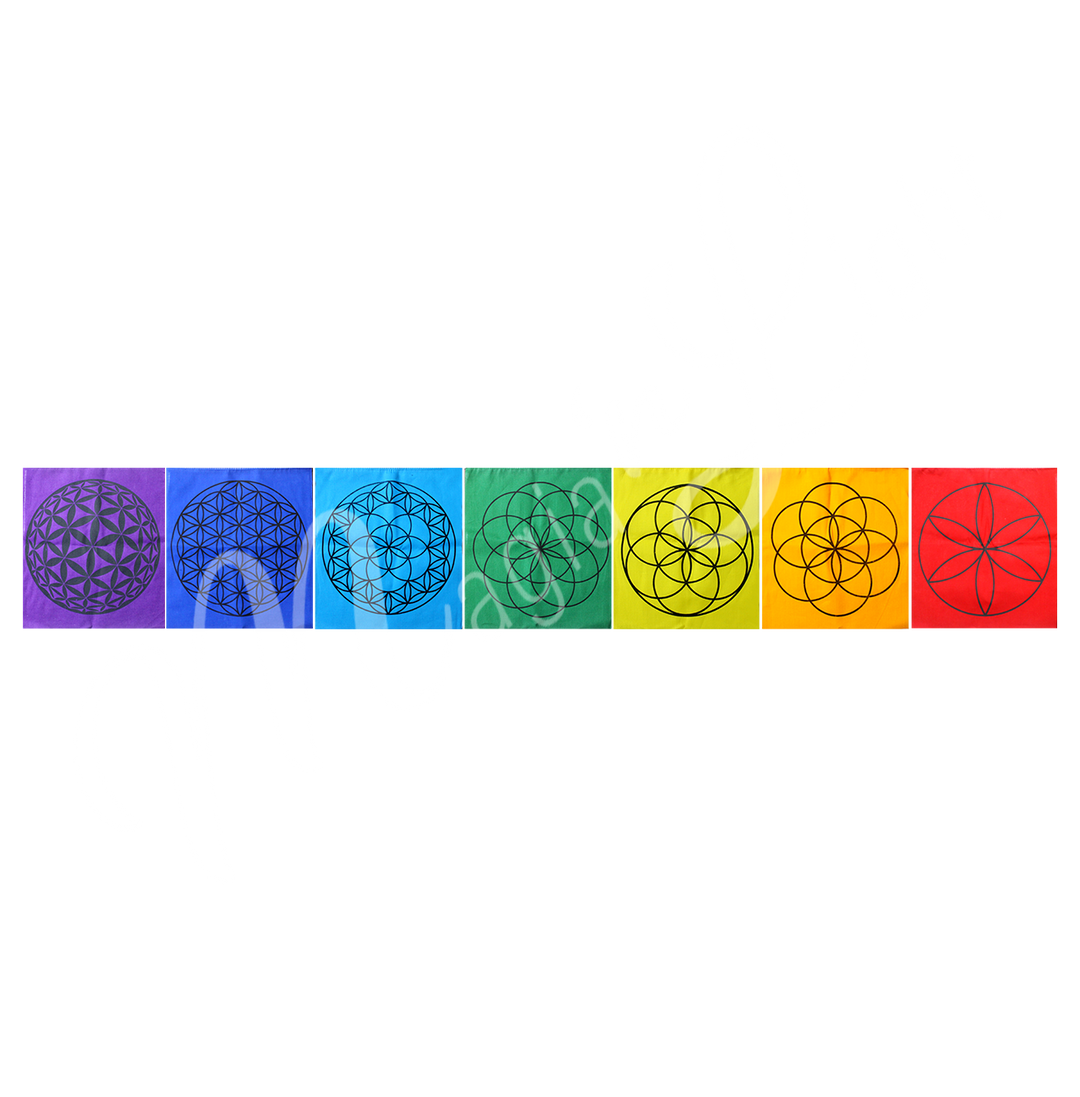 Seven rectangular pieces of fabric in chakra colors with corresponding symbols, placed side by side.