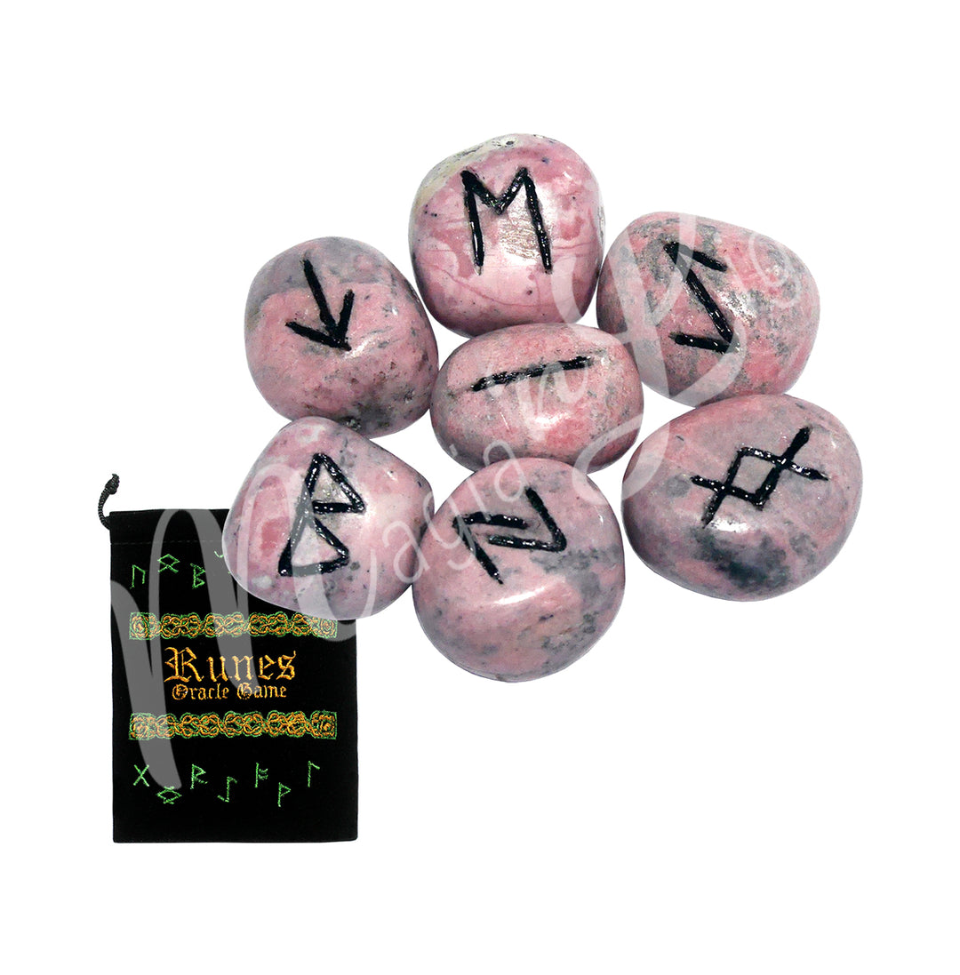 A set of rhodonite runestones with engraved and painted black symbols, displayed with a black velvet pouch. The pouch is embroidered with the words "runes oracle game", as well as runic symbols.