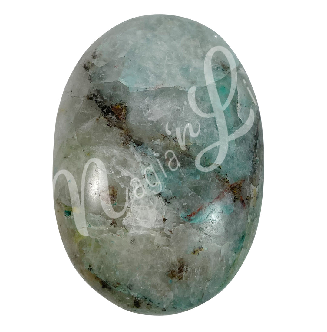 Close-up of a polished oval palm stone made of quartz with chrysocolla.
