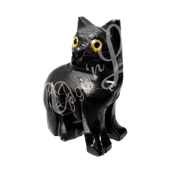 A black onyx cat with yellow eyes and an engraved pentacle on its side. Seen at an angle.