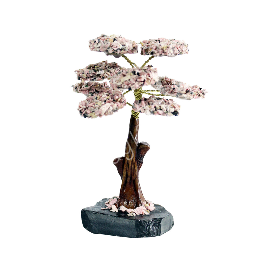 A wire gemstone bonsai tree with rhodonite crystal chips, mounted on a natural black onyx base.