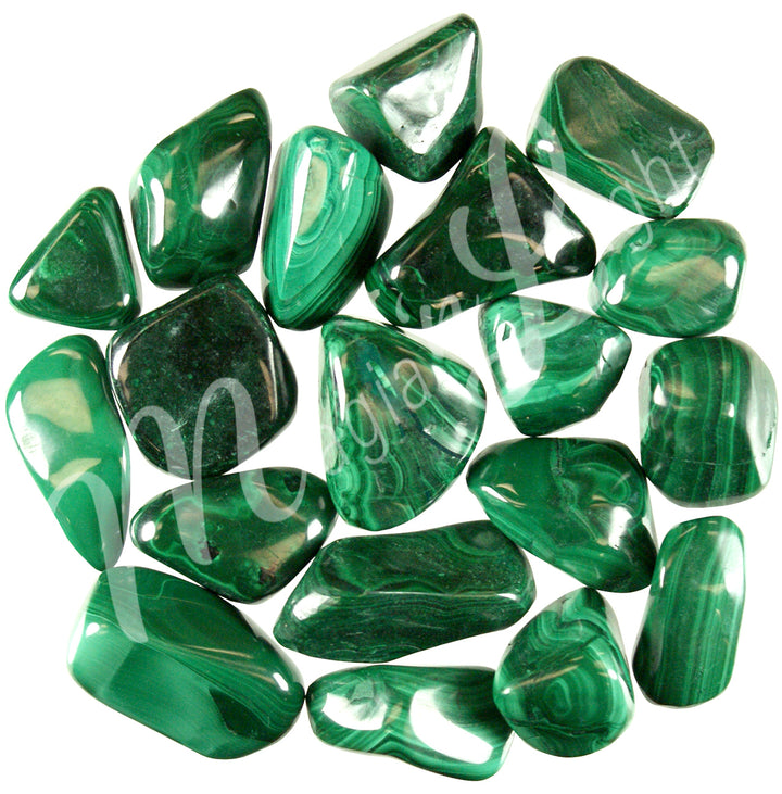 Collection of polished tumbled stones in shades of green, dark green, and turquoise, arranged together in a circular pile.