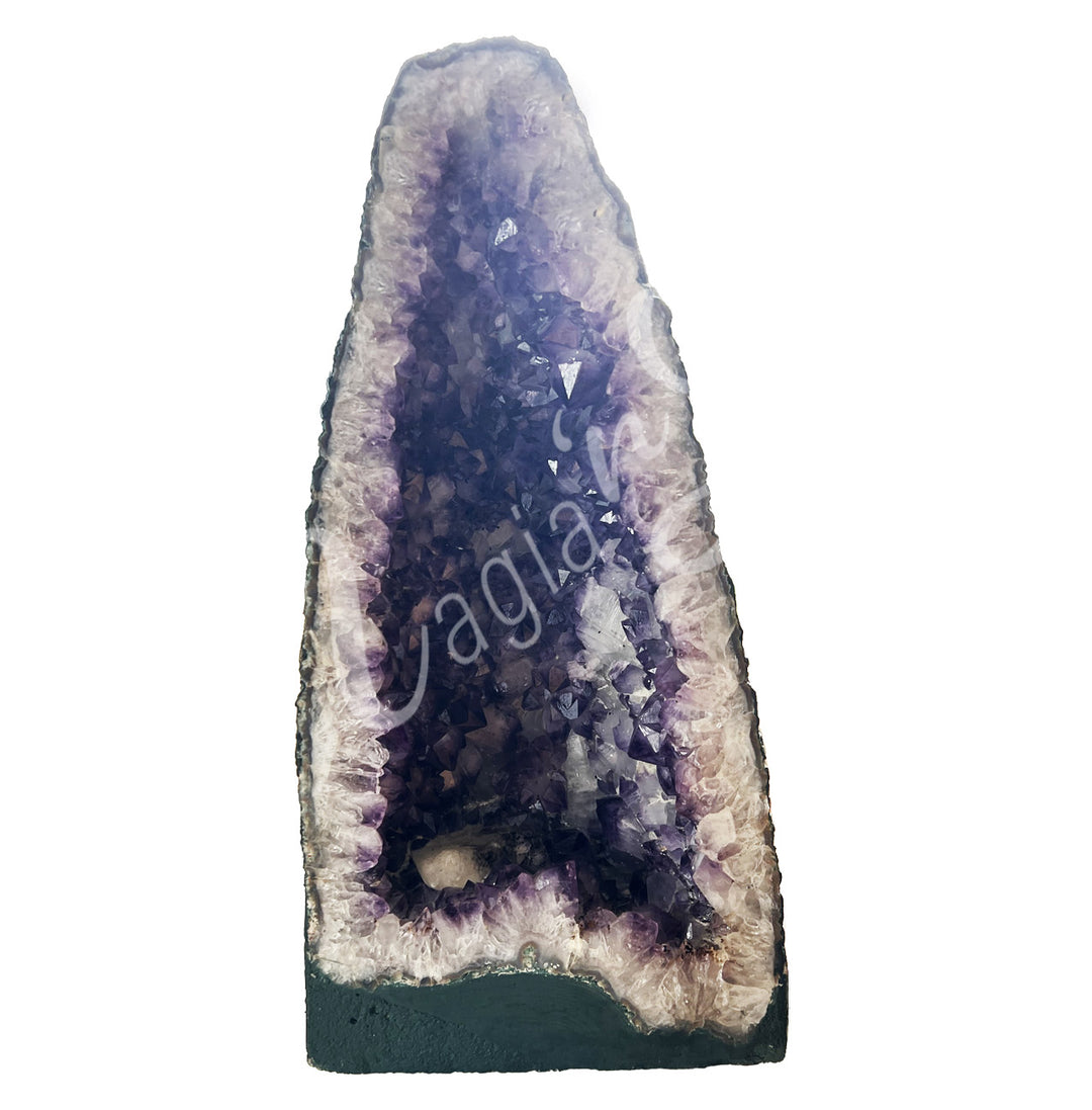 Front view of a long amethyst cathedral. The center is purple with glitter while the sides go from white to black on the exterior.