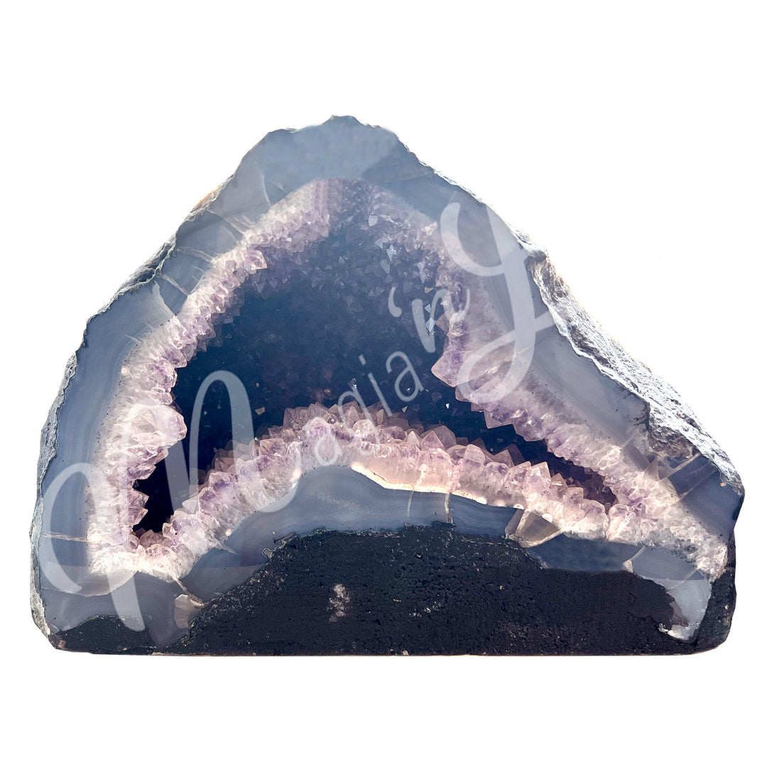 Front view of an amethyst cathedral. The center is purple with glitter while the sides go from white to gray on the exterior.