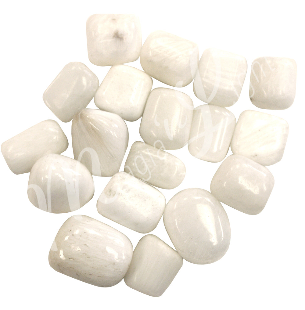 Collection of polished tumbled stones in shades of white, arranged together in a circular pile.