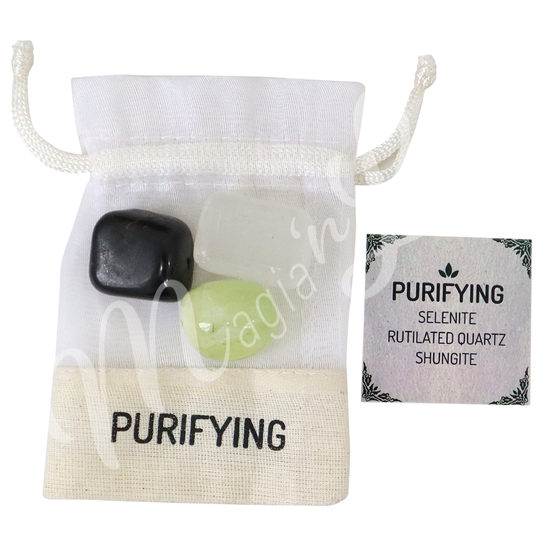 A white drawstring pouch labeled “PURIFYING,” displayed with three polished stones—Selenite, Rutilated Quartz, and Shungite—alongside a tag that reads “PURIFYING: Selenite, Rutilated Quartz, Shungite.”