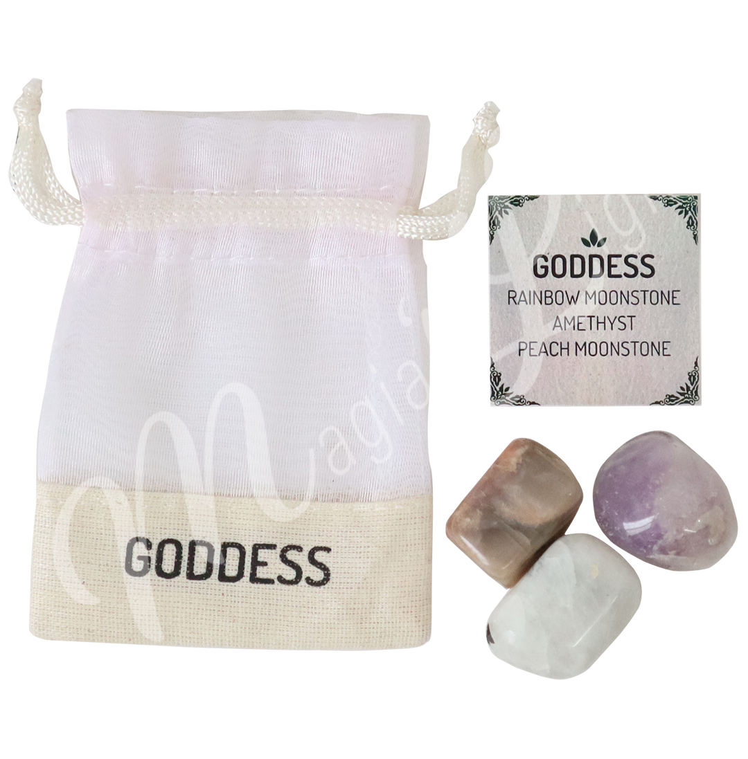 A white drawstring pouch labeled “GODDESS” alongside a tag that reads “GODDESS: Rainbow Moonstone, Amethyst, Peach Moonstone.”
Three polished stones at the bottom—Rainbow Moonstone, Amethyst, and Peach Moonstone.