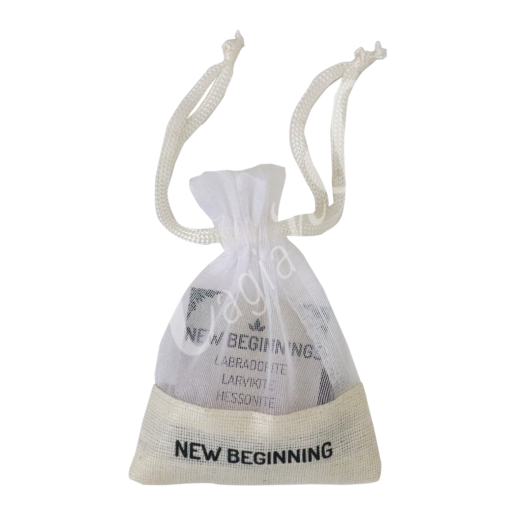 A small white drawstring pouch labeled “NEW BEGINNING”.