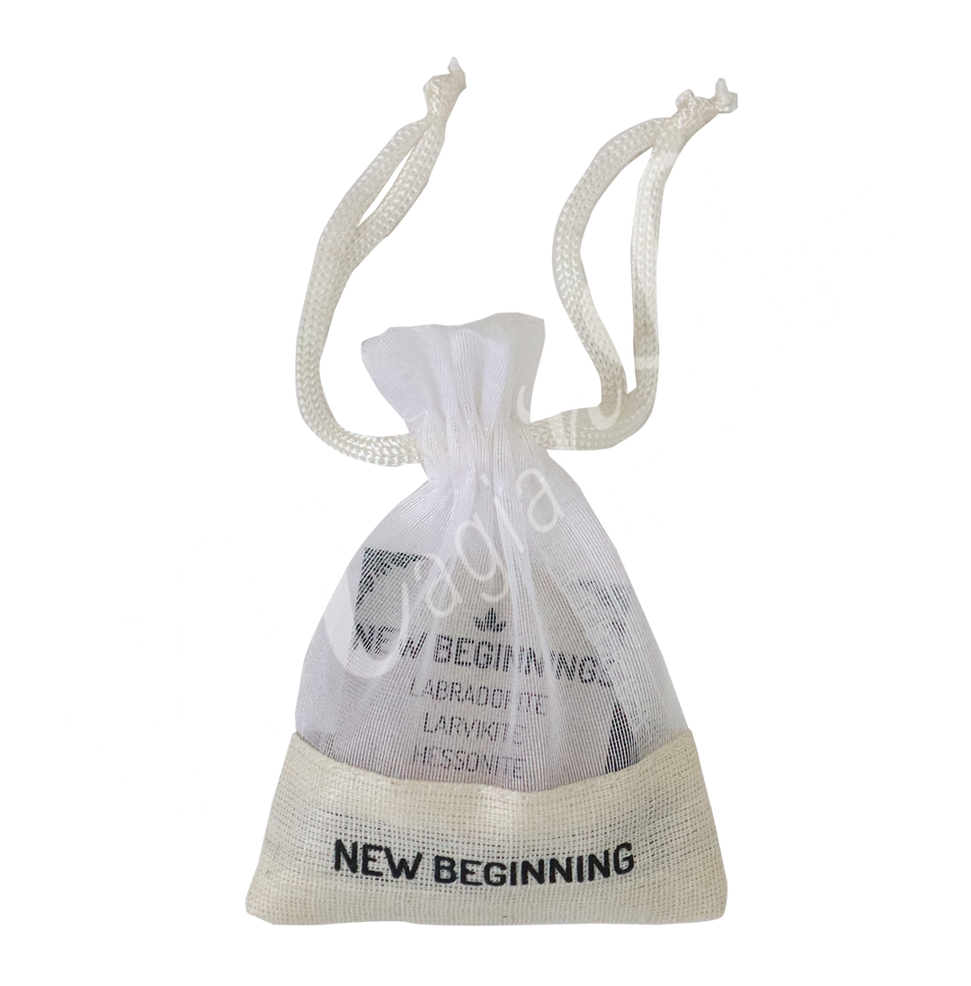 A small white drawstring pouch labeled “NEW BEGINNING”.