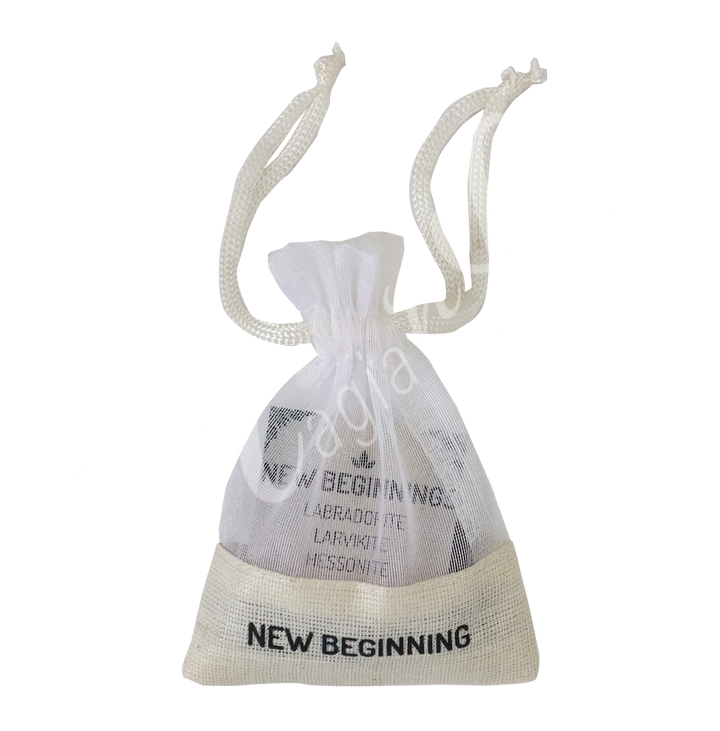 A small white drawstring pouch labeled “NEW BEGINNING”.