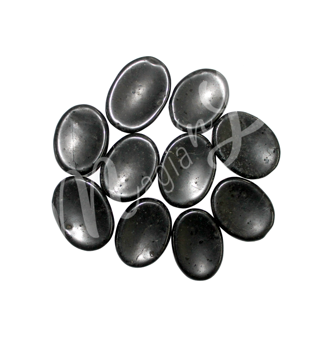 A collection of polished black stones with smooth oval shapes, showing natural color variations and patterns.