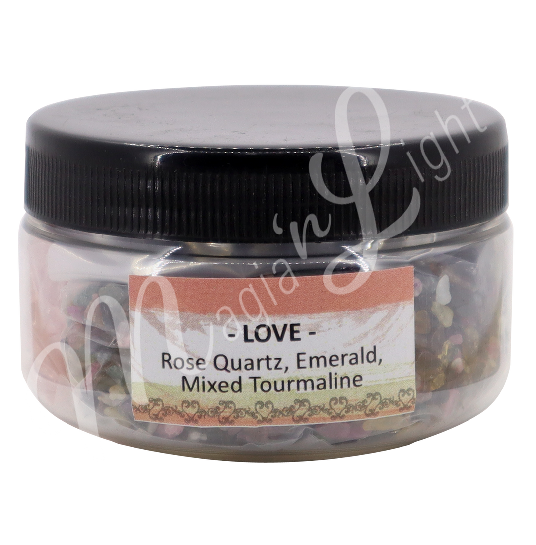 A transparent jar with black lid. The label reads "Love" "Rose Quartz, Emerald & Miced Tourmaline".