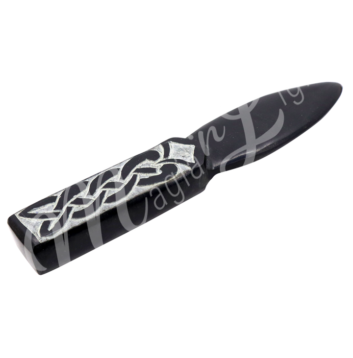 Athame made from Black Soapstone with an Celtic Knot engraving on the handle. Measuring 7" in length. Seen at an angle.