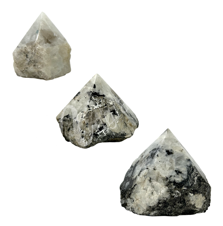 Three pieces of white stone with black specks. The top is cut to form a point.