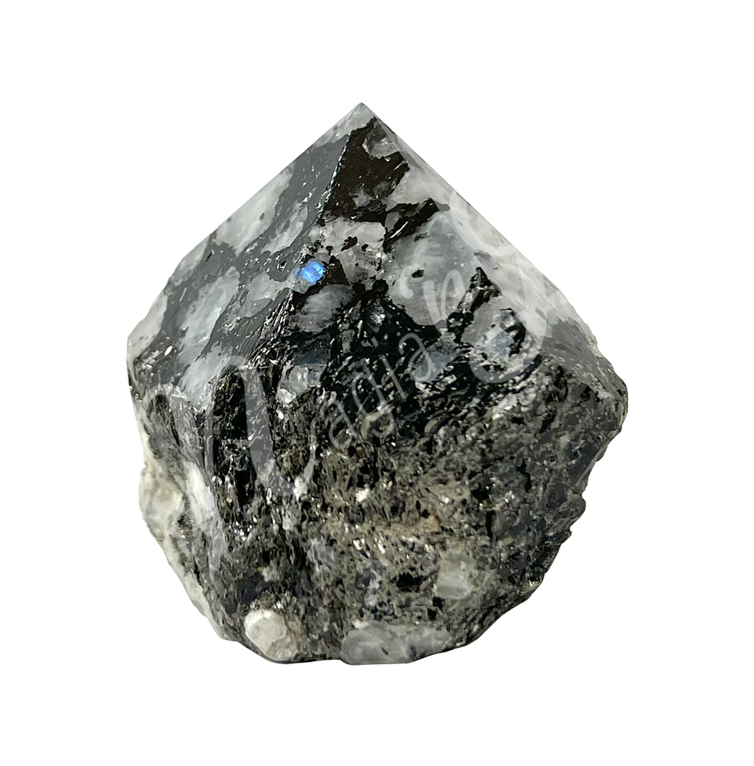A piece of black stone with white specks. The top is cut to form a point.