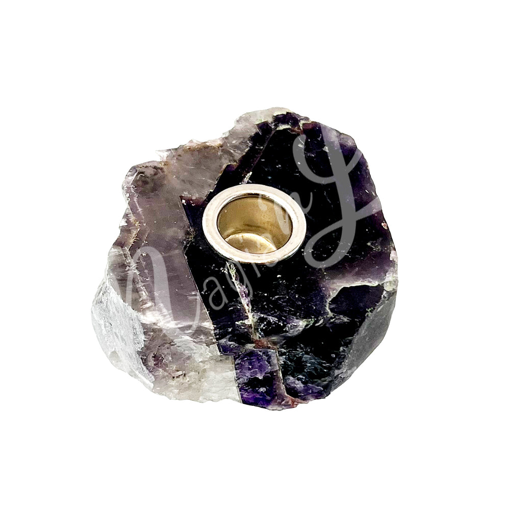 A natural amethyst tealight candle holder with metal insert.