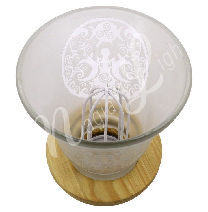 Empty decorative frosted glass cup lamp with etched Goddess design, wooden base, metal piece in the middle.